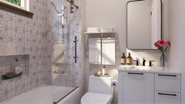 Bathroom view of the 450-square-foot, 15-by-30-foot attached one-bedroom casita, showing patterned shower and vanity.