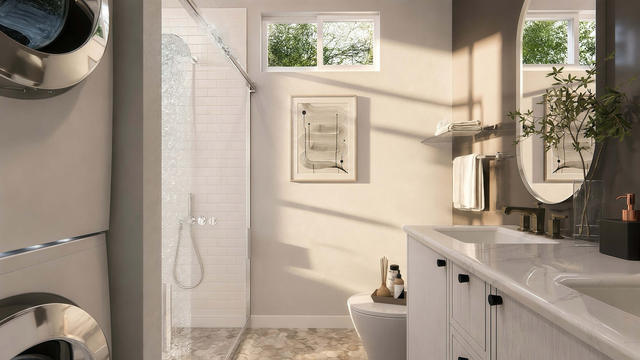 Interior rendering of the full bathroom showing a vanity, toilet, shower, window, and stacked laundry equipment