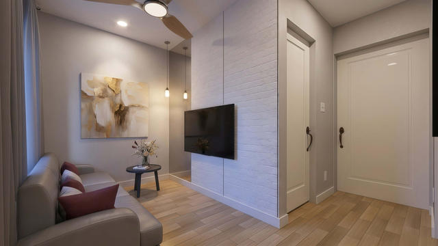 Office view of the 360-square-foot, 21-by-12-foot attached casita, showing the compact office and media wall.