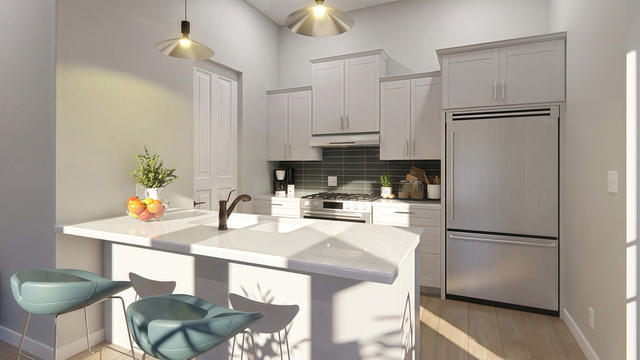Kitchen view of the 638-square-foot, 24-by-26-foot one-bedroom casita with full-width porch, showing the kitchen cabinetry and island.