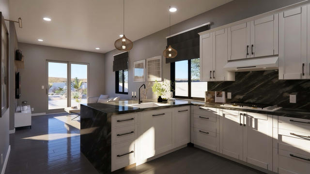 Interior rendering of the casita kitchen showing white cabinetry, island seating, dark counters, and patio doors