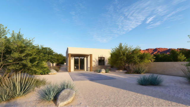 Wide front rendering of the 25 by 58 casita showing the entry volume, low roofline, driveway, and desert planting