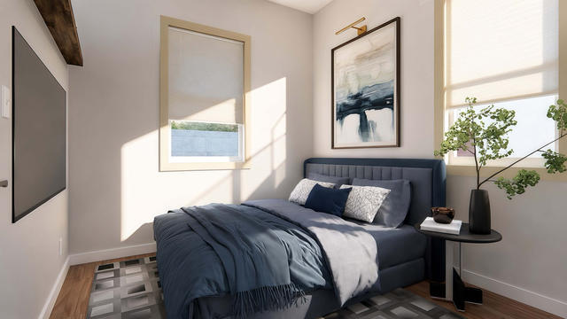 One-bedroom casita interior with a bed set between two windows