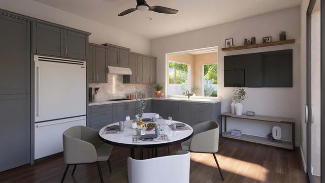 Kitchen And Dining view of the 510 sq ft 34' x 15' casita with covered patio floor plan, showing the kitchen and dining area with an island, table seating, cabinetry, and media wall.
