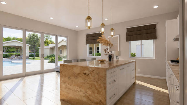 Kitchen view of the 748-square-foot, 34-by-22-foot one-bedroom casita, showing the island, cabinetry, and pool-facing doors.