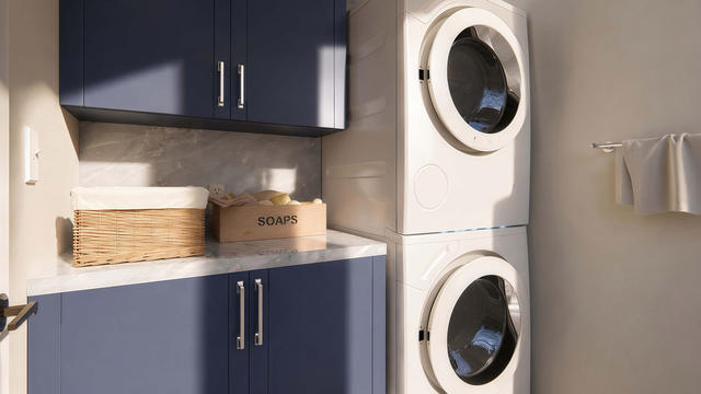 Laundry view of the 1,200-square-foot three-bedroom casita with a 34-by-37-foot-6-inch overall extent, showing stacked laundry and cabinets.