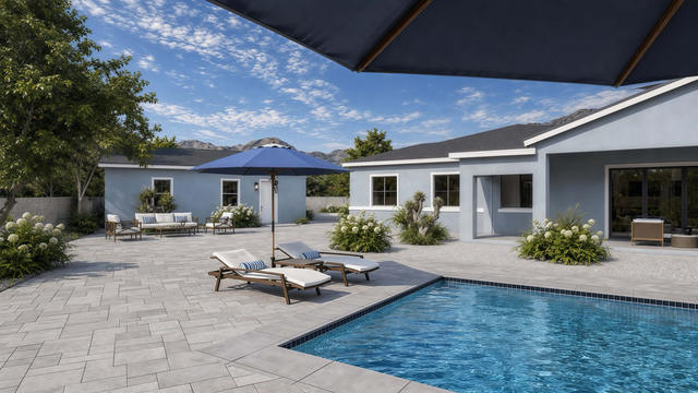 Rear exterior rendering of the casita showing doors and windows opening toward a paved patio and pool setting