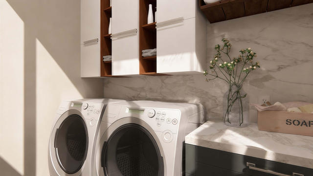 Interior rendering of the laundry area showing side-by-side appliances, storage cabinetry, counter space, and daylight
