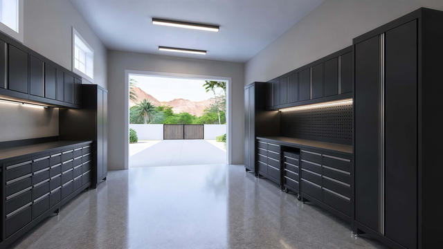 Interior rendering of the attached garage showing wall storage, work cabinets, overhead lighting, and the open garage door