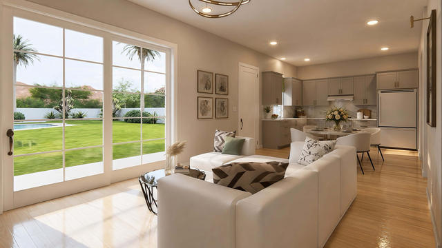 Interior rendering of the open living and kitchen area showing seating, cabinetry, French doors, and natural light