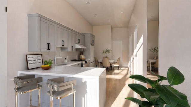 Living Room view of the 689-square-foot casita with 1,355-square-foot attached garage, showing the main seating area and windows.