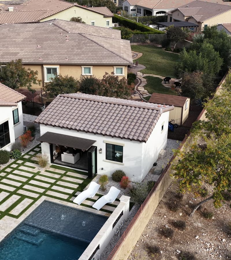Buckeye studio casita beside the pool with tile roof, patio pavers, and desert landscaping
