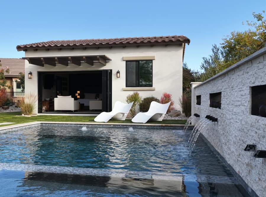 Buckeye studio casita exterior beside the backyard pool with folding doors open toward the patio