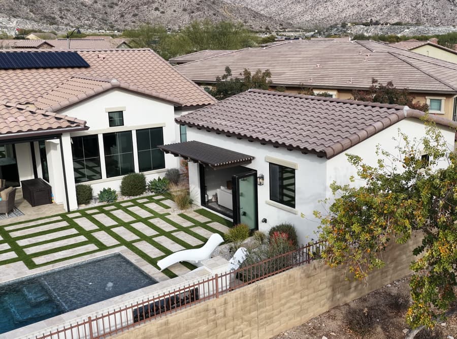 Elevated backyard view of the Buckeye studio casita with pool, tile roof, and Arizona mountain backdrop