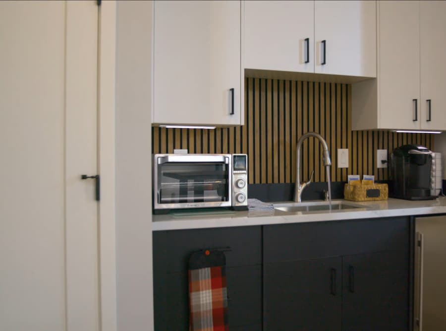 Compact kitchenette inside Mr. Zoe's Buckeye studio casita with microwave, sink, and storage cabinets