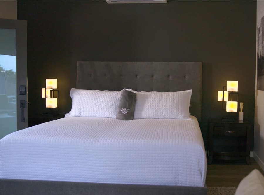 Sleeping area in the Buckeye studio casita with bed, nightstands, and dark accent wall