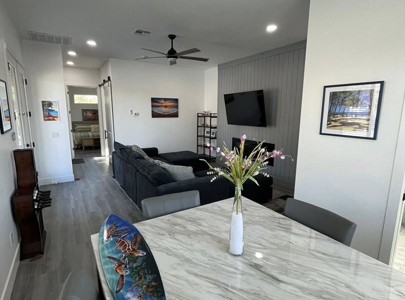Cave Creek casita ADU dining and living area with surfboard decor and gray feature wall