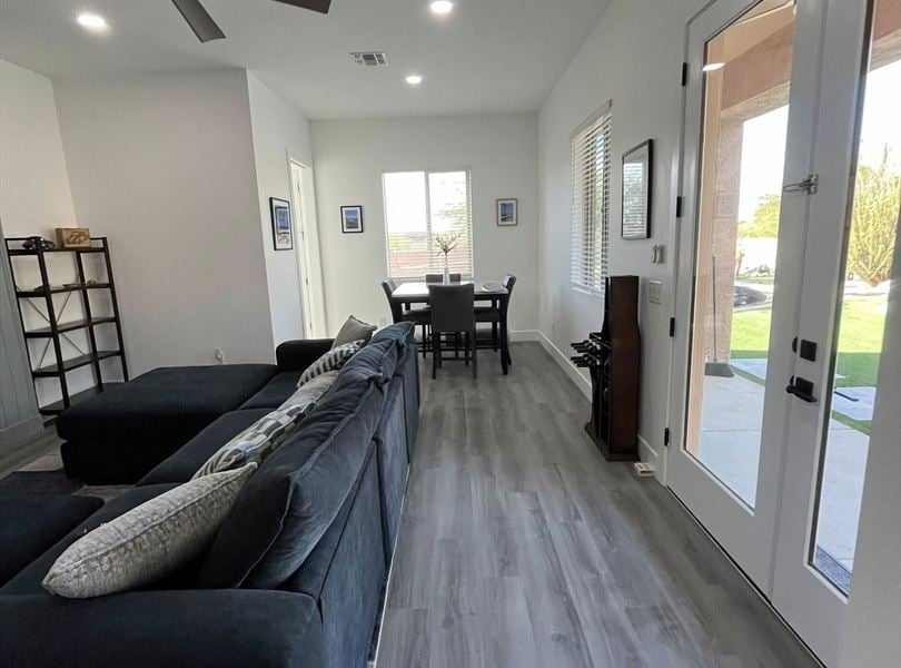 Cave Creek casita ADU living room hallway with sofa, dining nook, and glass exterior doors