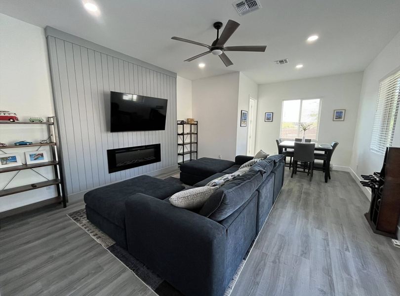 Cave Creek casita ADU living room with gray feature wall, fireplace, and dining nook