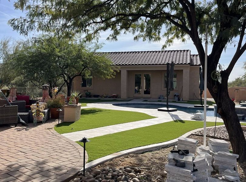 Covered patio, pool, and Cave Creek casita ADU exterior under desert trees