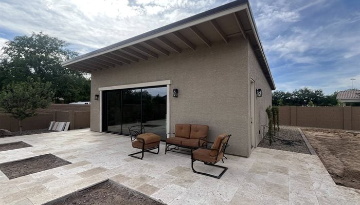 Finished Queen Creek pool house with patio overhang and backyard entertaining space