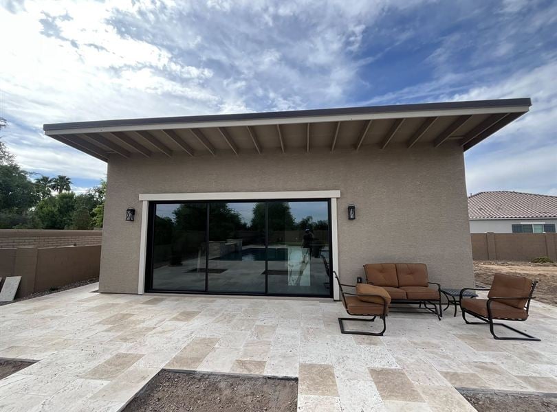 Front elevation of the finished Queen Creek pool house with wide patio overhang