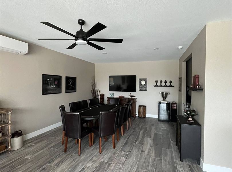Finished pool house theater room with recliners, wall-mounted TV, and popcorn cart