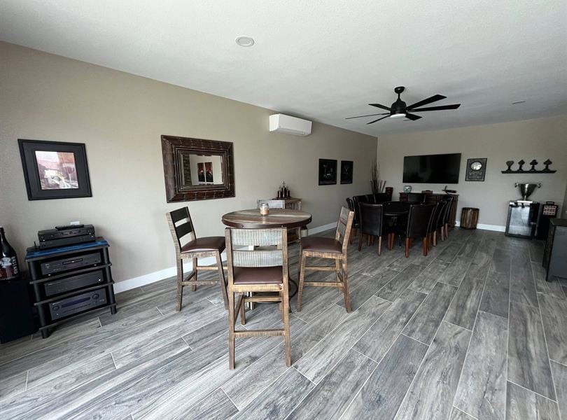Queen Creek pool house game area with dining table, tile floor, and media wall