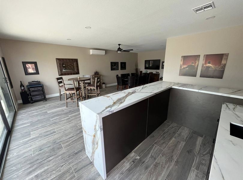 Wide interior view of Queen Creek pool house with bar, lounge area, and open entertainment space