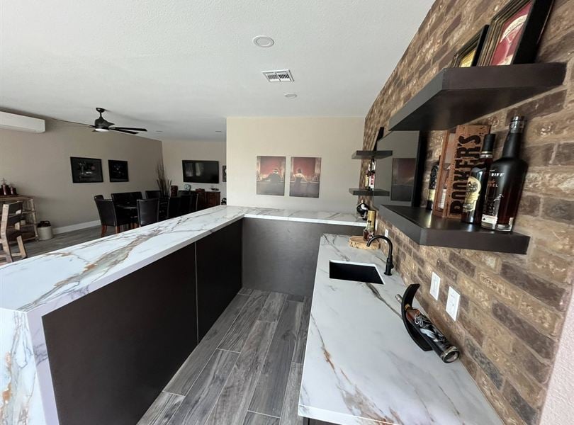 Queen Creek pool house bar and lounge area with stone counters and seating