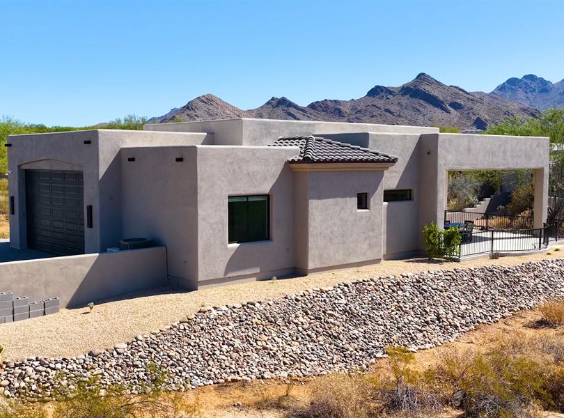 Exterior view of Scottsdale casita with stucco walls and mountain backdrop
