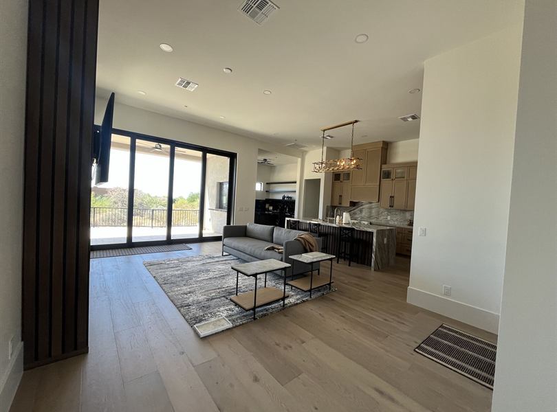 Open casita living space with kitchen, sofa, and patio views