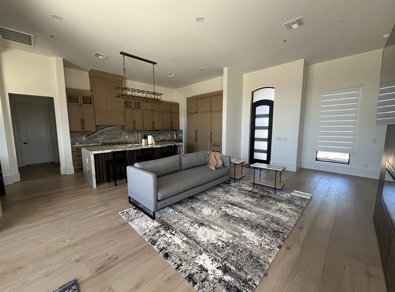 Furnished casita living room with kitchen and natural light