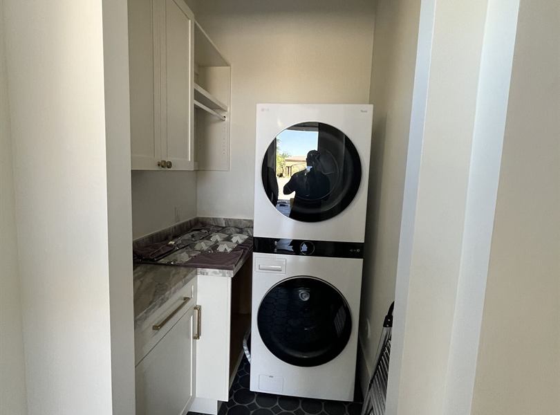 Compact casita laundry area with stacked washer and dryer